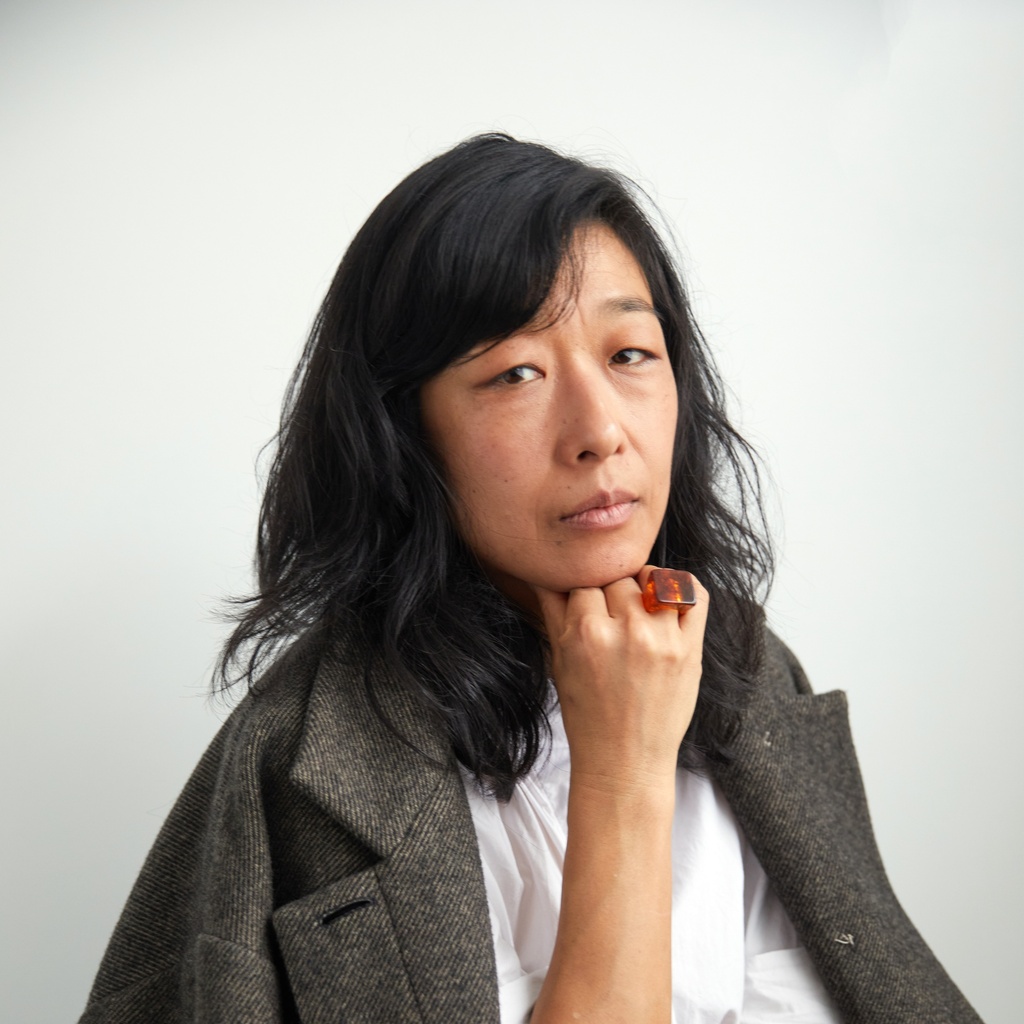 Youna Kwak in a large, gray wool coat