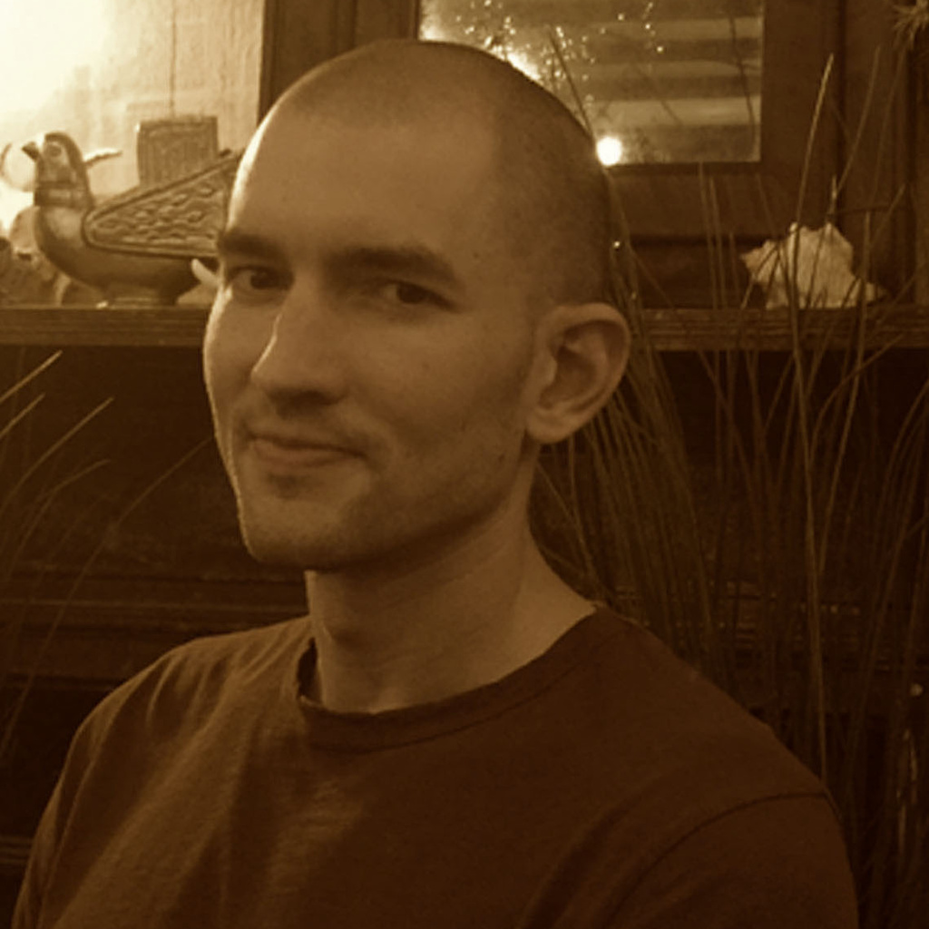 A sepia-tone headshot of Geoff Peck